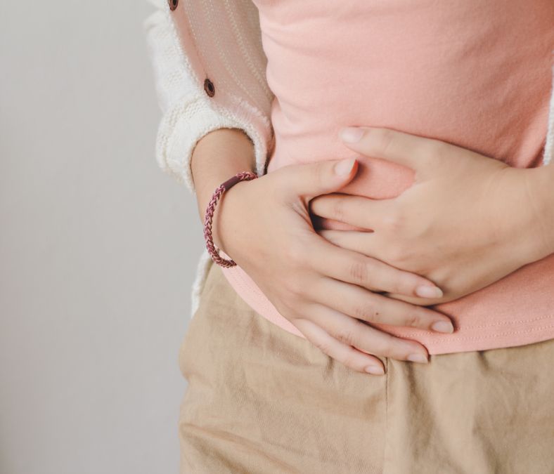 Lady with hands clasped on her stomach